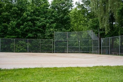 Baseball field backstop and bleachers in public park Stock Photos