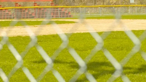 Baseball Field Through Chain Link Fence SLIDE LEFT Stock Footage 107389750