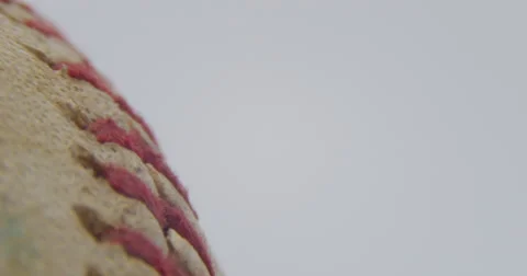 Baseball Game Ball Rotating Slowly Macro Close Up on White, 4K Stock Footage 66195940