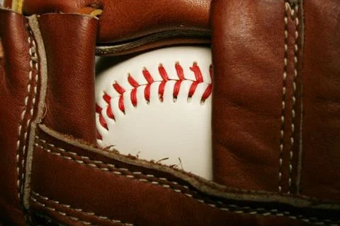 Baseball in a glove Stock Photos