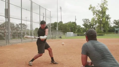 Baseball hitting training with coach tossing Stock Footage 157940674