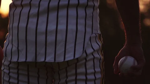 Baseball man wielding a baseball with the light of the sunset Stock Footage 106137875