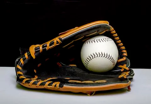 Baseball Mitt With A White Baseball In Webbing 写真素材