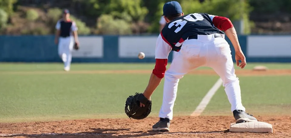 Baseball pitcher, catching ball while Stock Photos