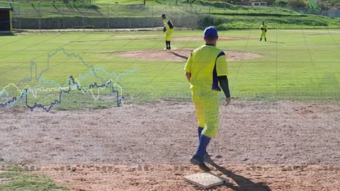 Baseball pitcher delivering pitch, first baseman stepping onto first base Stock Footage 333601584