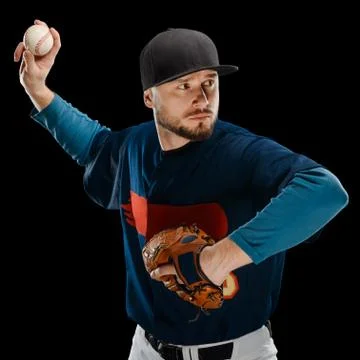 Baseball pitcher making a throw on black background Stock Photos