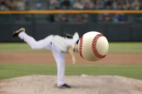 Baseball pitcher throwing fast ball to batter in a stadium Stock Photos