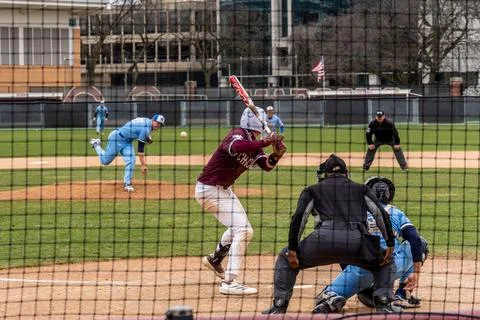 A baseball pitcher throws a ball with the batter ready during a game at the.. Stock Photos