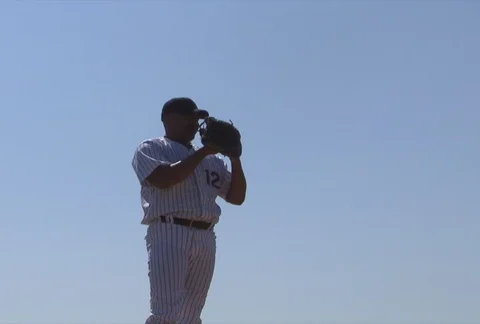 Baseball pitcher winding up and throwing fast ball toward home plate Stock Footage 86884340