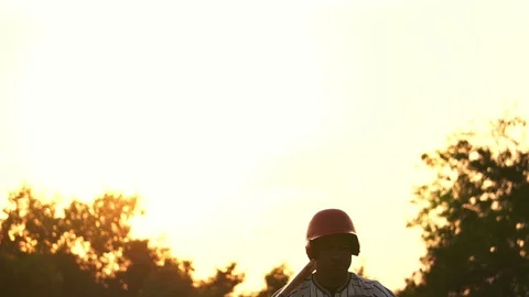 A baseball player and light of the sunset Stock Footage 106137571