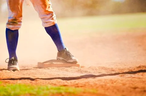 Baseball player on the base Stock Photos