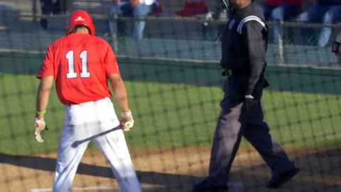 A baseball player batter makes a play at a game. Stock Footage 70493949