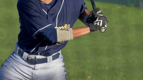A baseball player batter makes a play at a game. Stock Footage 70494143