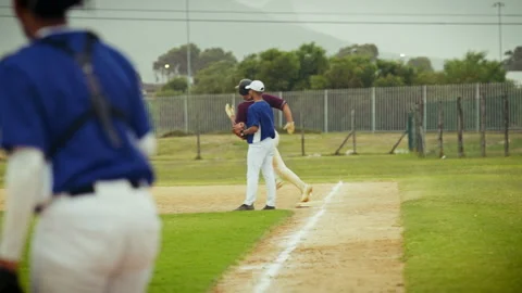 Baseball player hits and runs, successfully sliding into base Stock Footage 335272857