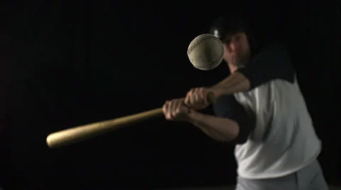 Baseball player hitting a ball with a bat, Slow Motion Stock Footage