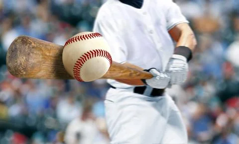 Baseball player hitting ball with bat in close up Foto stock