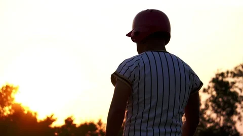 Baseball player holding a baseball with the light of sunset Stock Footage 106137254