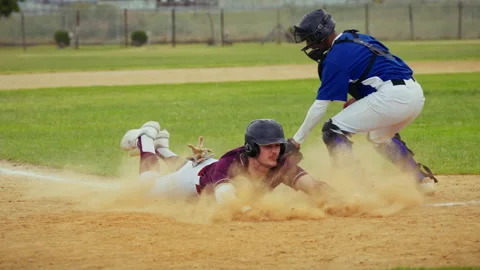 Baseball player slides into base during game Stock Footage 331007345