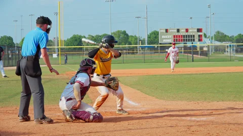 Baseball Player Standing On Home Plate and Swinging A Bat And Hitting The Stock Footage 237673514