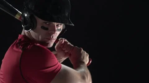 Baseball player swinging the bat, close up, black background Stock Footage 11524217