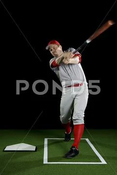 A Baseball Player Swinging A Bat