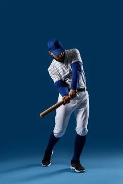 Baseball player in uniform with cap and bat, athletic sports training and com Stock Photos