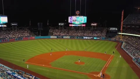 Baseball players during game in Dodger Stadium at night. Panning, Los Stock Footage 151225231