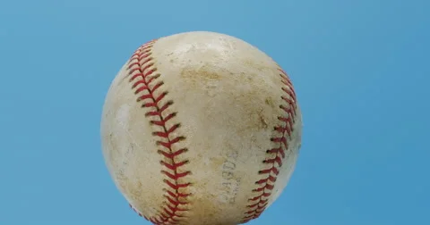 Baseball with Red Stitching Rotating Isolated on Blue 10bit, 4K Stock Footage 66546195