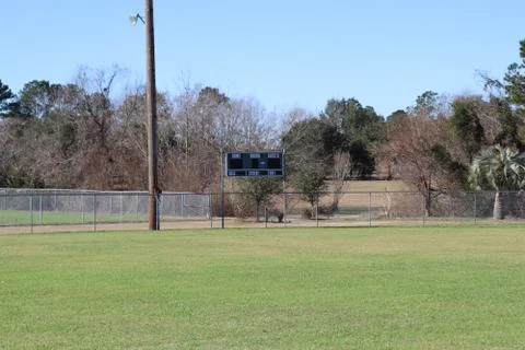 Baseball scoreboard from distance with tree background Stock Photos