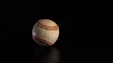 A baseball spinning on a black background. 4K Stock Footage 123635678