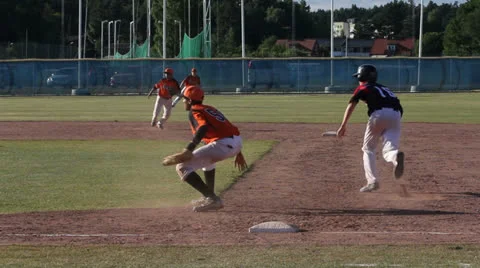 Baseball, tagged at first base Stock Footage 25824425