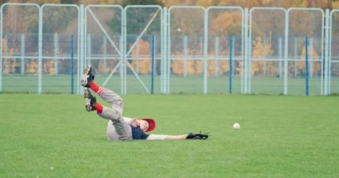 Baseball tournament at school, the boy pitcher did not catch the fastball Stock Footage 252260275