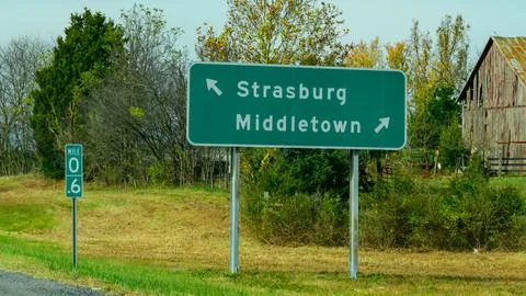 Based on the road signs, this image captures a rural highway intersection i.. Stock Photos