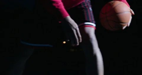 Basektball Player Dribbles Side to Side at Night with Dramatic Lighting Stock Footage 129820408