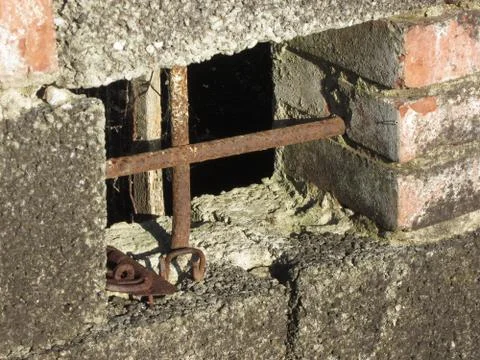 Basement window with rusty iron bars on old abandoned brick house Stock Photos