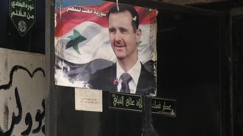 Bashar al-Assad's picture hanged at Burj Al - Barajneh Palestinian Refugee Camp Stock Footage 120594845