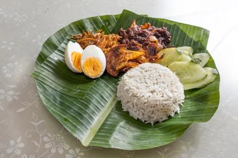 Basic authentic simple nasi lemak on banana leaf with sambal, anchovis and eg Stock Photos