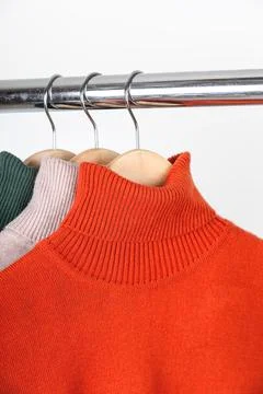 Basic autumn women's wardrobe concept. Blank turtleneck sweaters on clothes Stock Photos