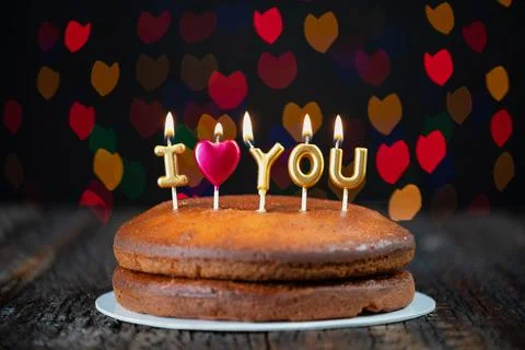 Basic cake with I love you candles, heart, placed on a vintage table and Stock Photos