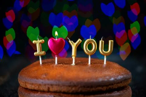 Basic cake with I love you candles, heart, placed on a vintage table and Stock Photos