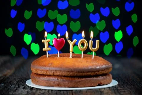Basic cake with I love you candles, heart, placed on a vintage table and Stock Photos