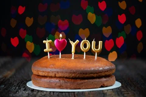 Basic cake with I love you candles, heart, placed on a vintage table and Stock Photos