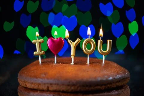Basic cake with I love you candles, heart, placed on a vintage table and Stock Photos