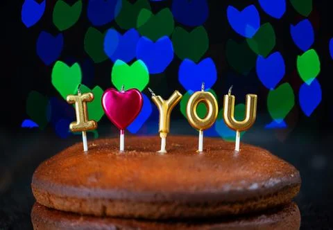 Basic cake with I love you candles, heart, placed on a vintage table and Stock Photos