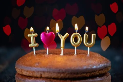 Basic cake with I love you candles, heart, placed on a vintage table and Stock Photos