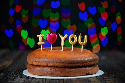 Basic cake with I love you candles, heart, placed on a vintage table and Stock Photos