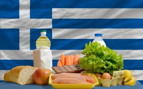 Basic food groceries in front of greece national flag Foto stock