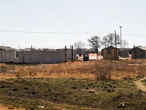 Basic housing for the poor in compound on outskirts of city. Stock Photos