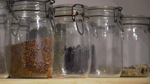 Basic ingredients organic organised neat in jars, storage cupboard kitchen Video stock 294297913
