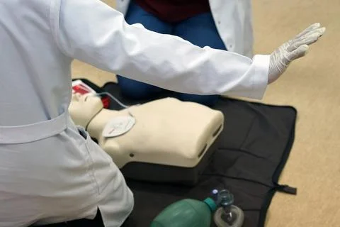 Basic life support simulation scenario for medical students on a dummy with.. Stock Photos